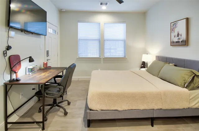 a bedroom with a bed and a window