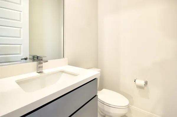 a kitchen with stainless steel appliances a sink a stove a window and cabinets