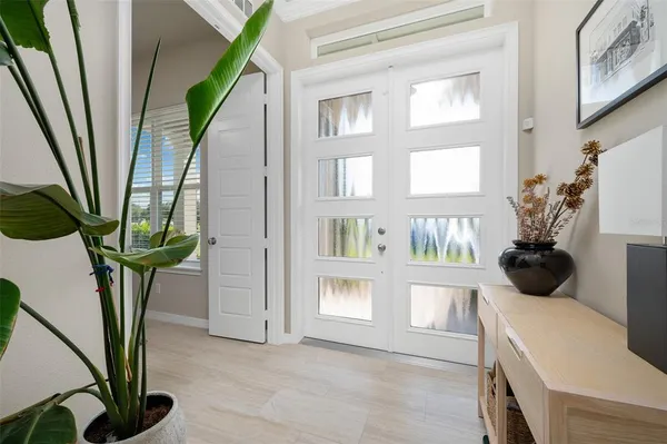 a living room with furniture a flat screen tv and a large window