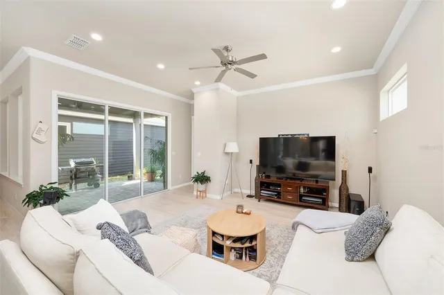 a kitchen with a sink a center island stainless steel appliances and cabinets