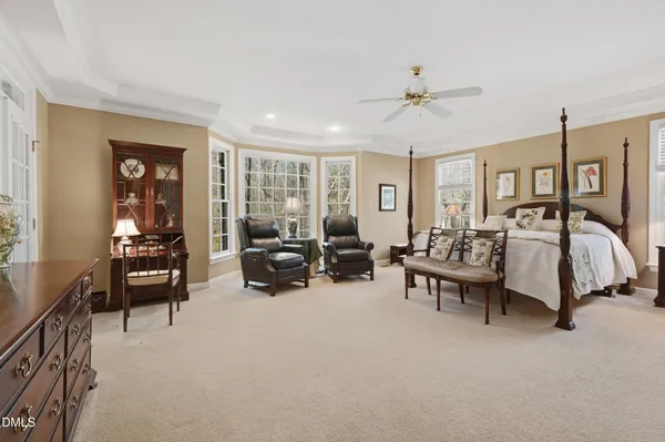a bedroom with furniture and a ceiling fan
