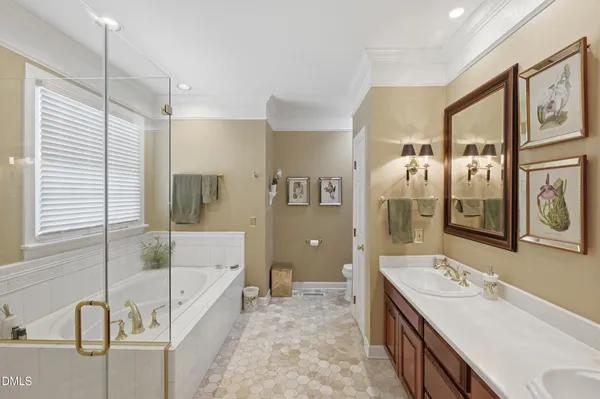 a bathroom with a tub sink shower and mirror