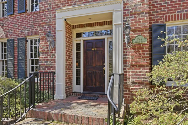 a front view of a house with a glass door and shower