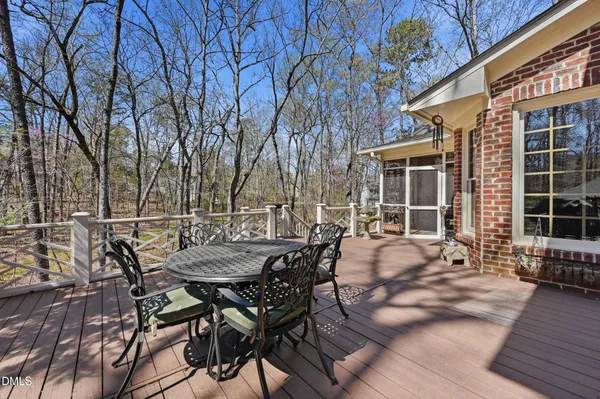 a view of a dinning table and chairs in patio of the house