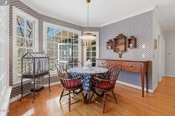 a view of a dining room with furniture window and wooden floor
