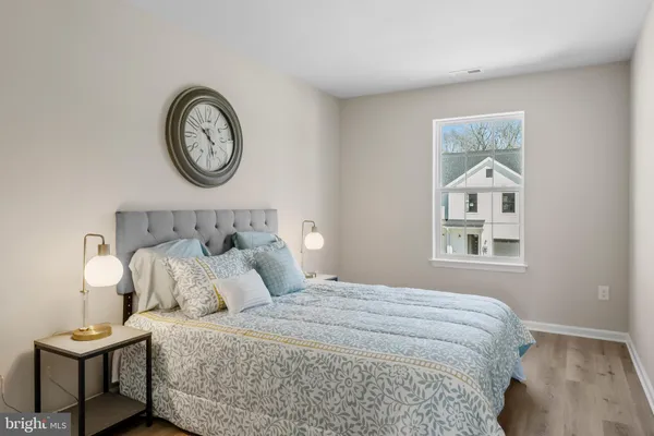 a bedroom with a bed and painting on the wall