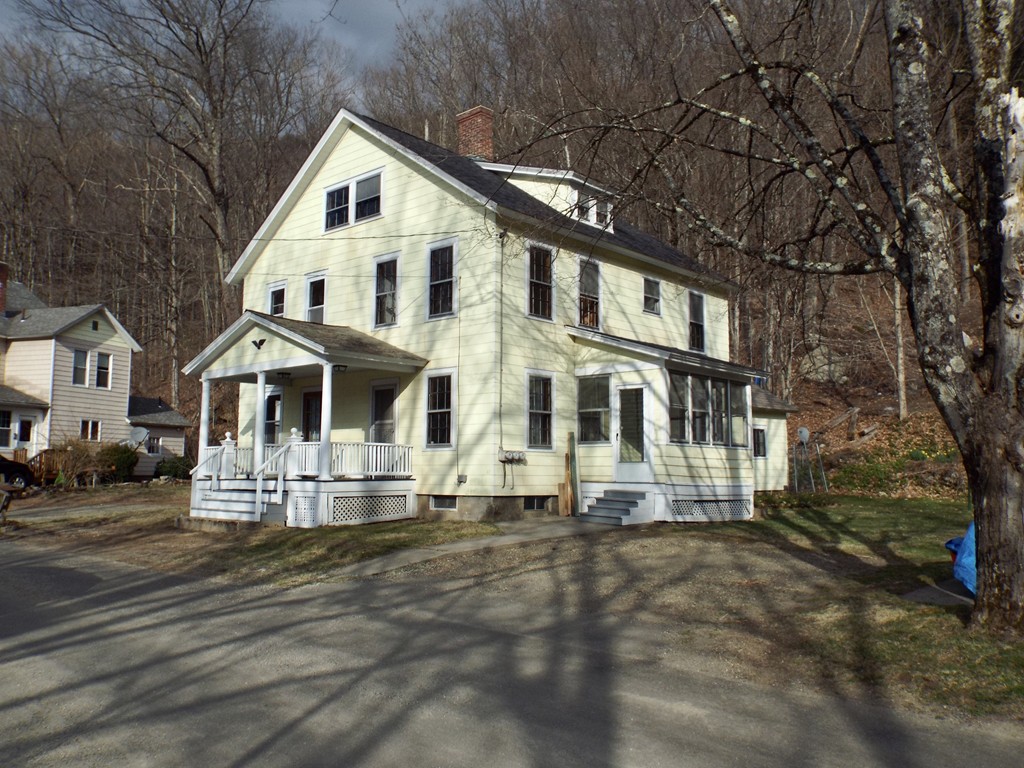 13 Church Street Colrain, MA 01340 - Photo 1 of 36 a view of a white house with large windows and fence