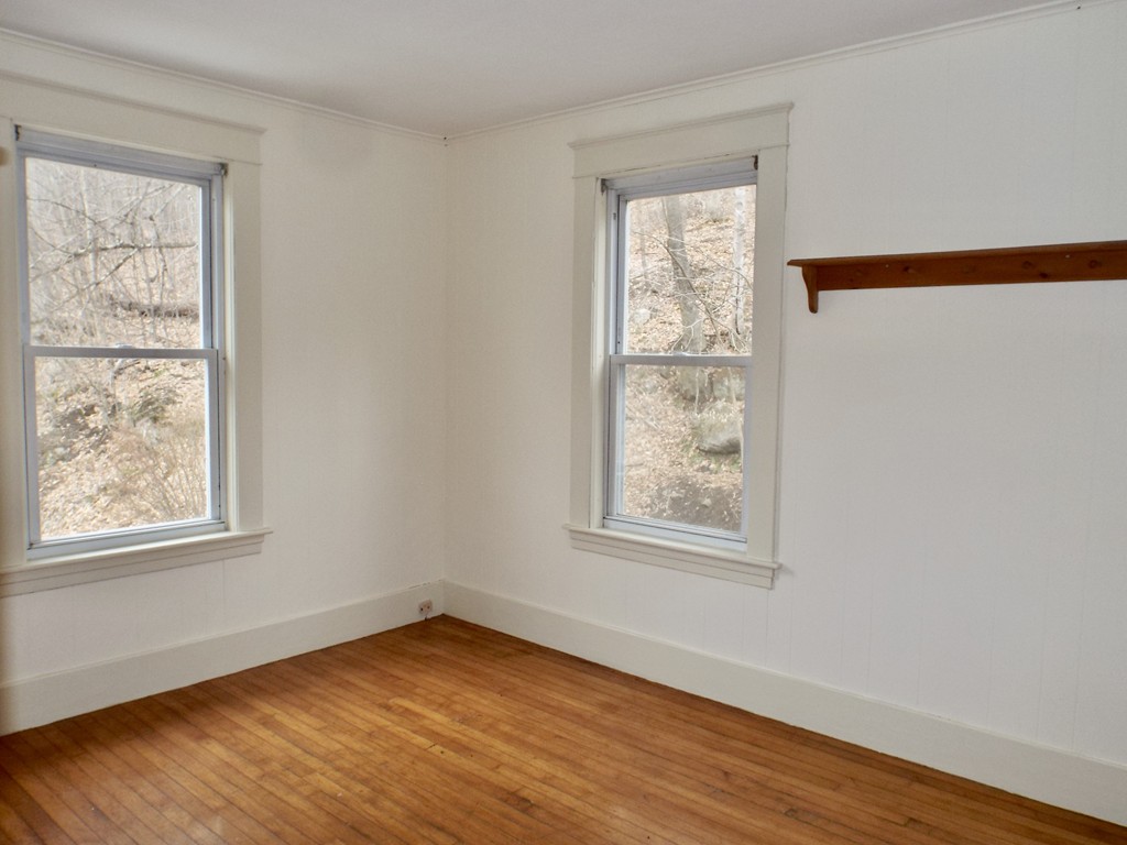 13 Church Street Colrain, MA 01340 - Photo 13 of 36 a view of an empty room with wooden floor and a window