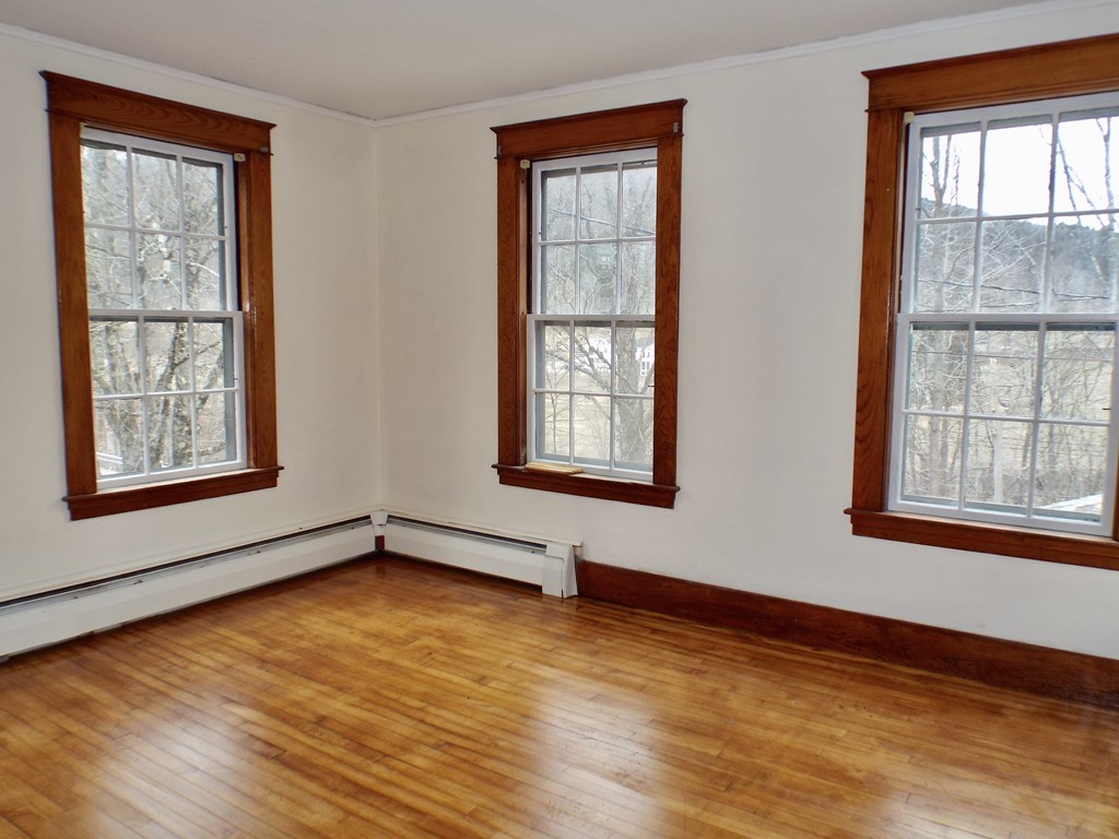 13 Church Street Colrain, MA 01340 - Photo 23 of 36 an empty room with wooden floor and windows