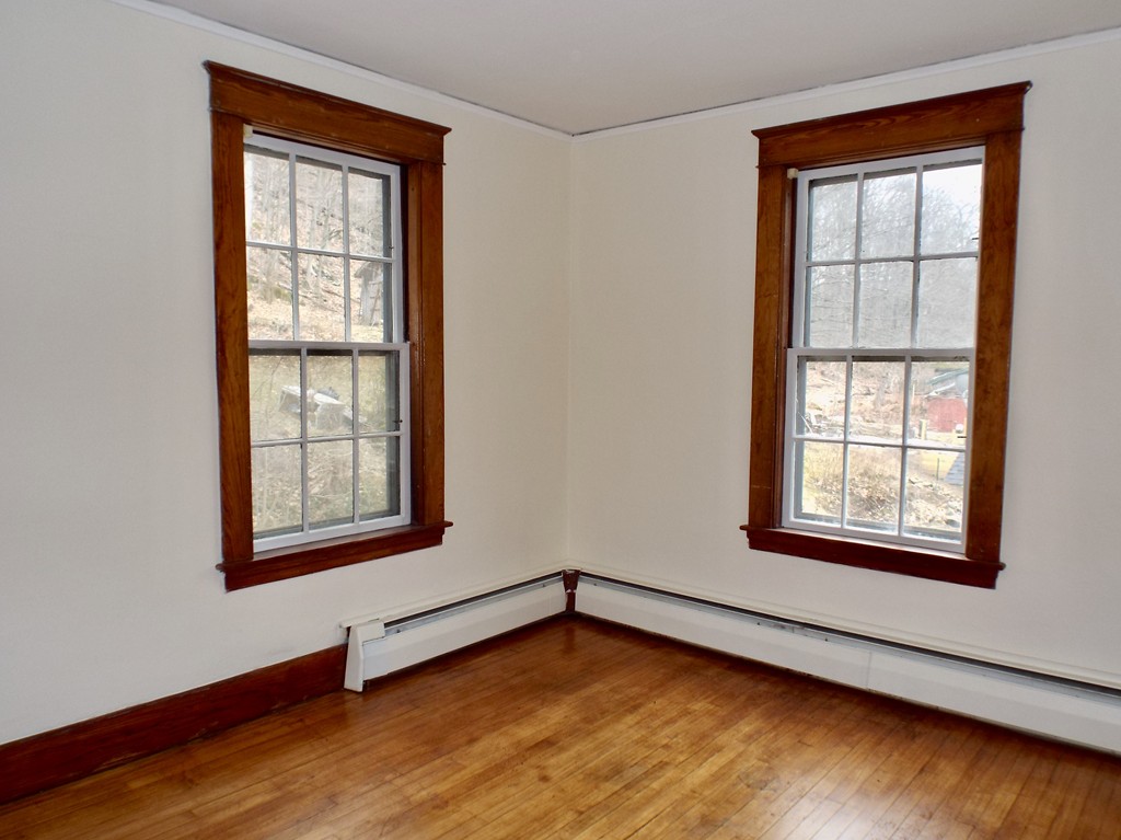 13 Church Street Colrain, MA 01340 - Photo 27 of 36 an empty room with wooden floor and windows