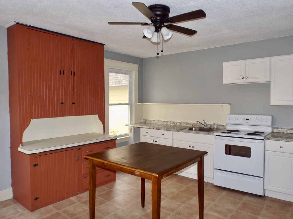 13 Church Street Colrain, MA 01340 - Photo 4 of 36 a kitchen with a stove a refrigerator and a sink