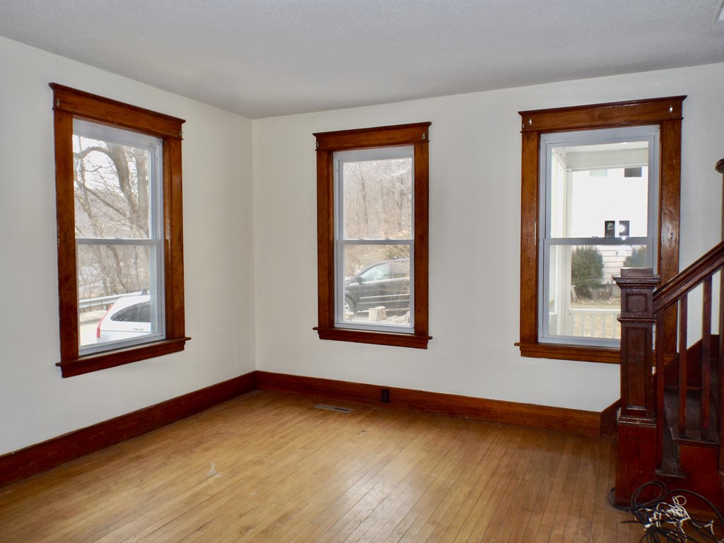 13 Church Street Colrain, MA 01340 - Photo 6 of 36 a view of an empty room with wooden floor and a window