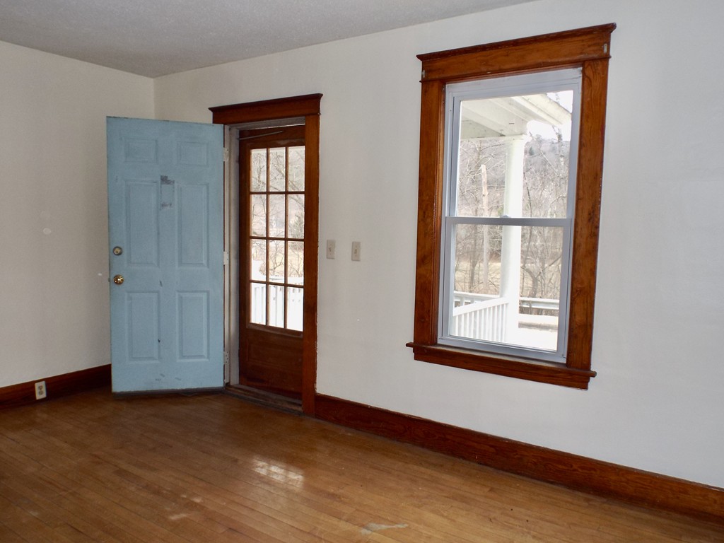 13 Church Street Colrain, MA 01340 - Photo 7 of 36 a view of an empty room with wooden floor and a window