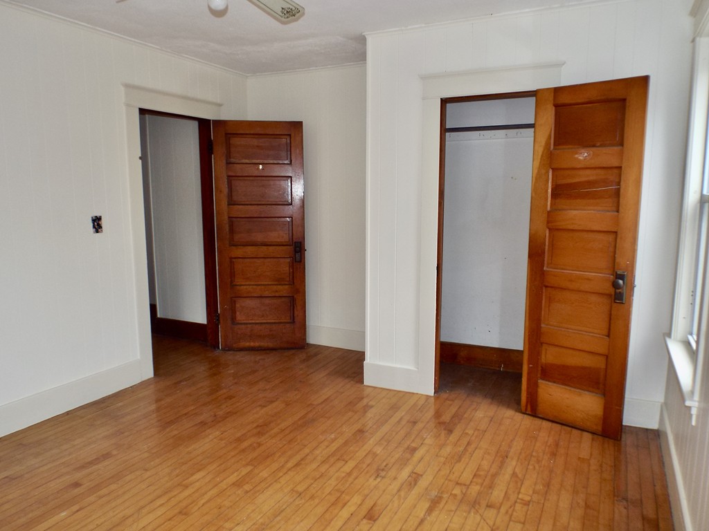 13 Church Street Colrain, MA 01340 - Photo 9 of 36 an empty room with wooden floor closet and windows