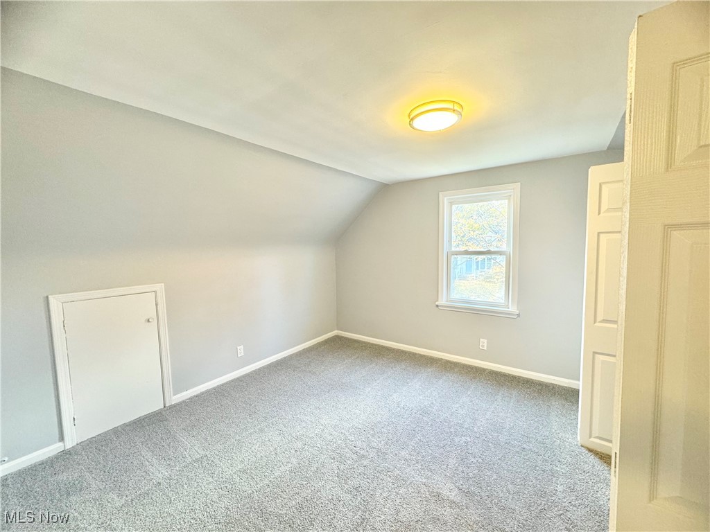 1215 Avondale Road Cleveland, OH 44121 - Photo 25 of 27 Bonus room with carpet flooring and vaulted ceiling