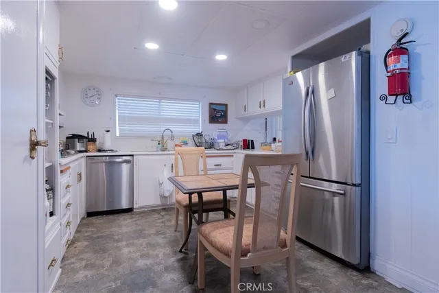 a kitchen with stainless steel appliances a refrigerator sink and cabinets