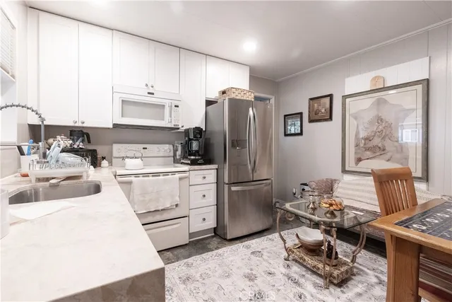 a kitchen with a refrigerator stove top oven and sink