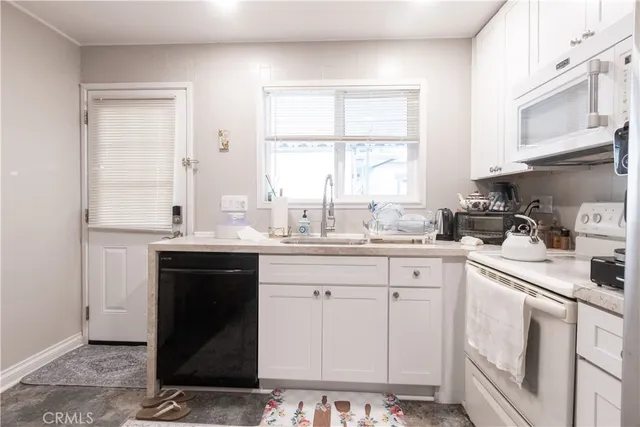 a kitchen with white cabinets and a sink