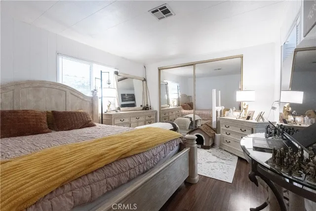 a bedroom with a bed a table and chair