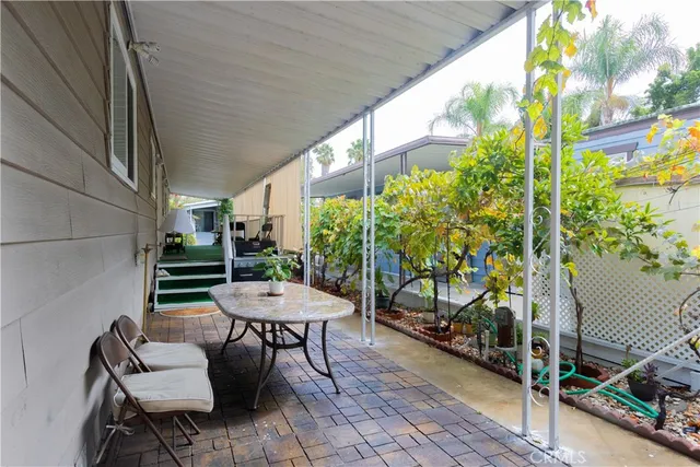 a view of a chairs and table in the balcony
