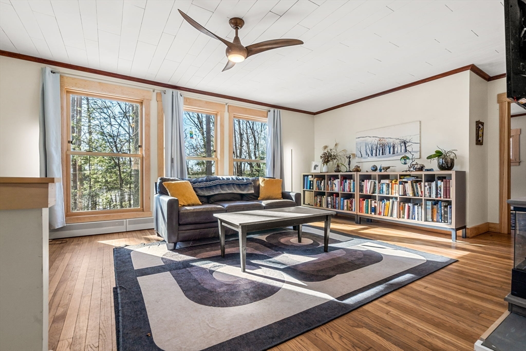 104 Island Road Lunenburg, MA 01462 - Photo 13 of 35 a living room with furniture a rug and a book shelf