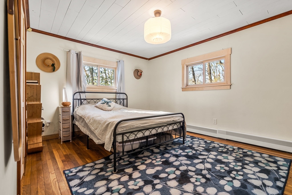 104 Island Road Lunenburg, MA 01462 - Photo 17 of 35 a bedroom with a bed and a lamp on dresser