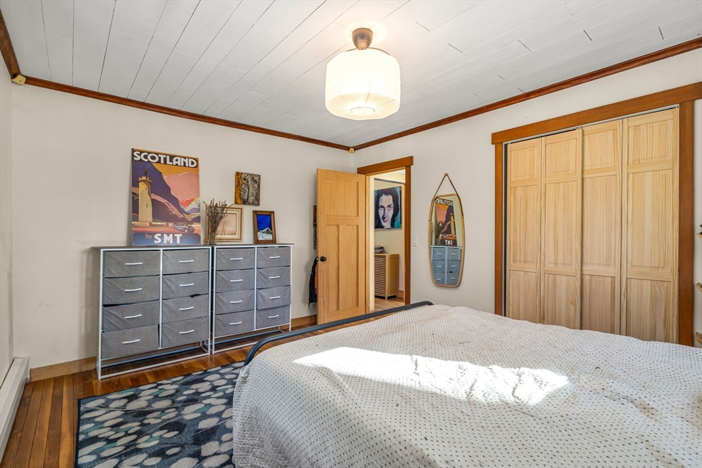 104 Island Road Lunenburg, MA 01462 - Photo 18 of 35 a bedroom with a bed and a chandelier