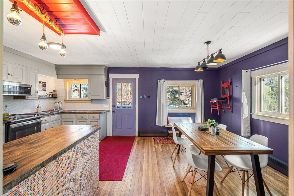 104 Island Road Lunenburg, MA 01462 - Photo 5 of 35 a kitchen with stainless steel appliances granite countertop a kitchen island hardwood floor sink stove dining table and chairs