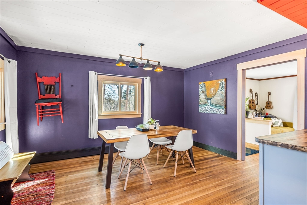 104 Island Road Lunenburg, MA 01462 - Photo 10 of 35 a view of a dining room with furniture wooden floor and a chandelier