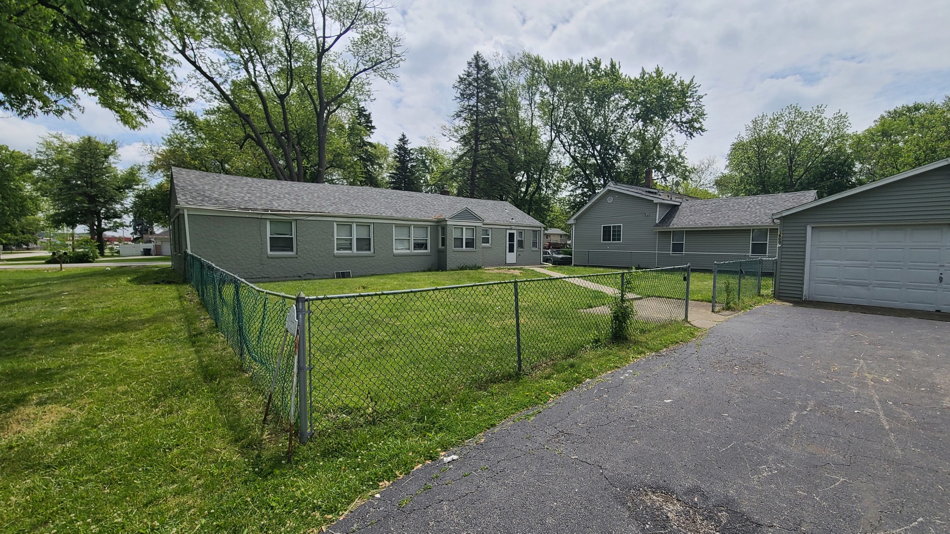 16002 Spaulding Avenue Markham, IL 60428 - Photo 2 of 4 a view of a house with a big yard plants and large tree