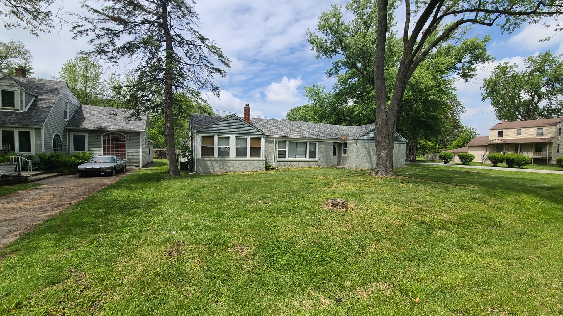 16002 Spaulding Avenue Markham, IL 60428 - Photo 4 of 4 a front view of a house with a garden and trees