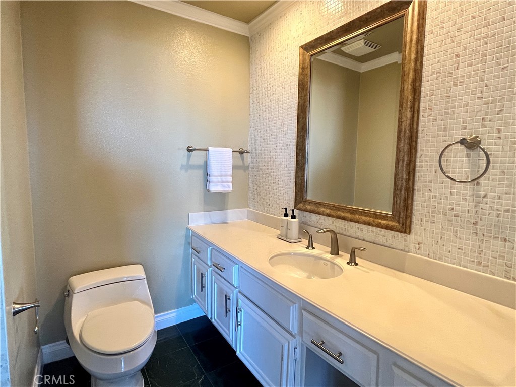 28115 Ridgepoint Court Rancho Palos Verdes, CA 90275 - Photo 20 of 31 a bathroom with a granite countertop toilet sink and mirror