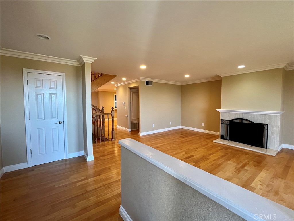 28115 Ridgepoint Court Rancho Palos Verdes, CA 90275 - Photo 6 of 31 a view of kitchen with kitchen island a sink wooden floor and a fireplace