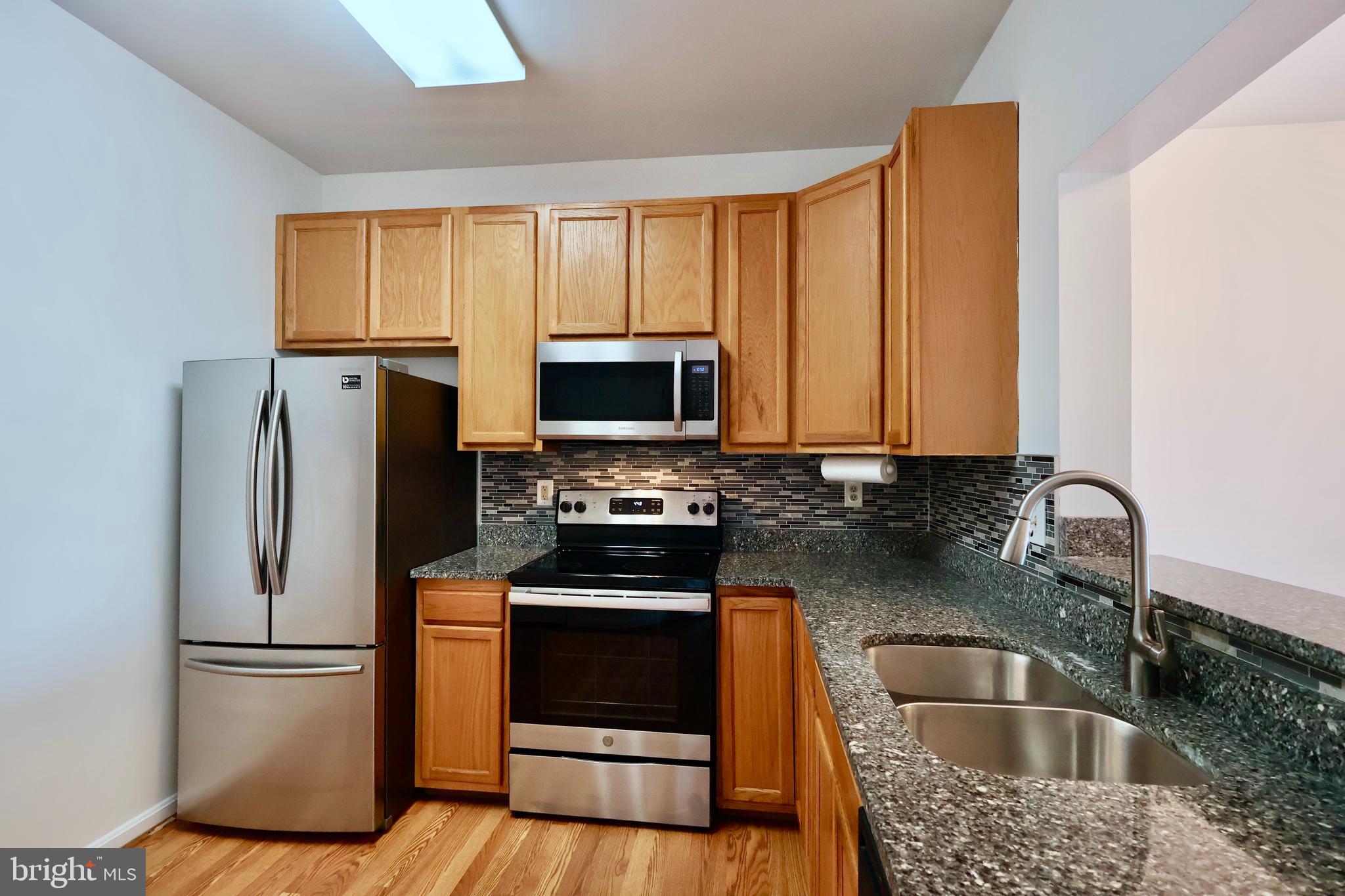 303 Three Sirens Odenton, MD 21113 - Photo 11 of 24 a kitchen with a refrigerator sink and microwave