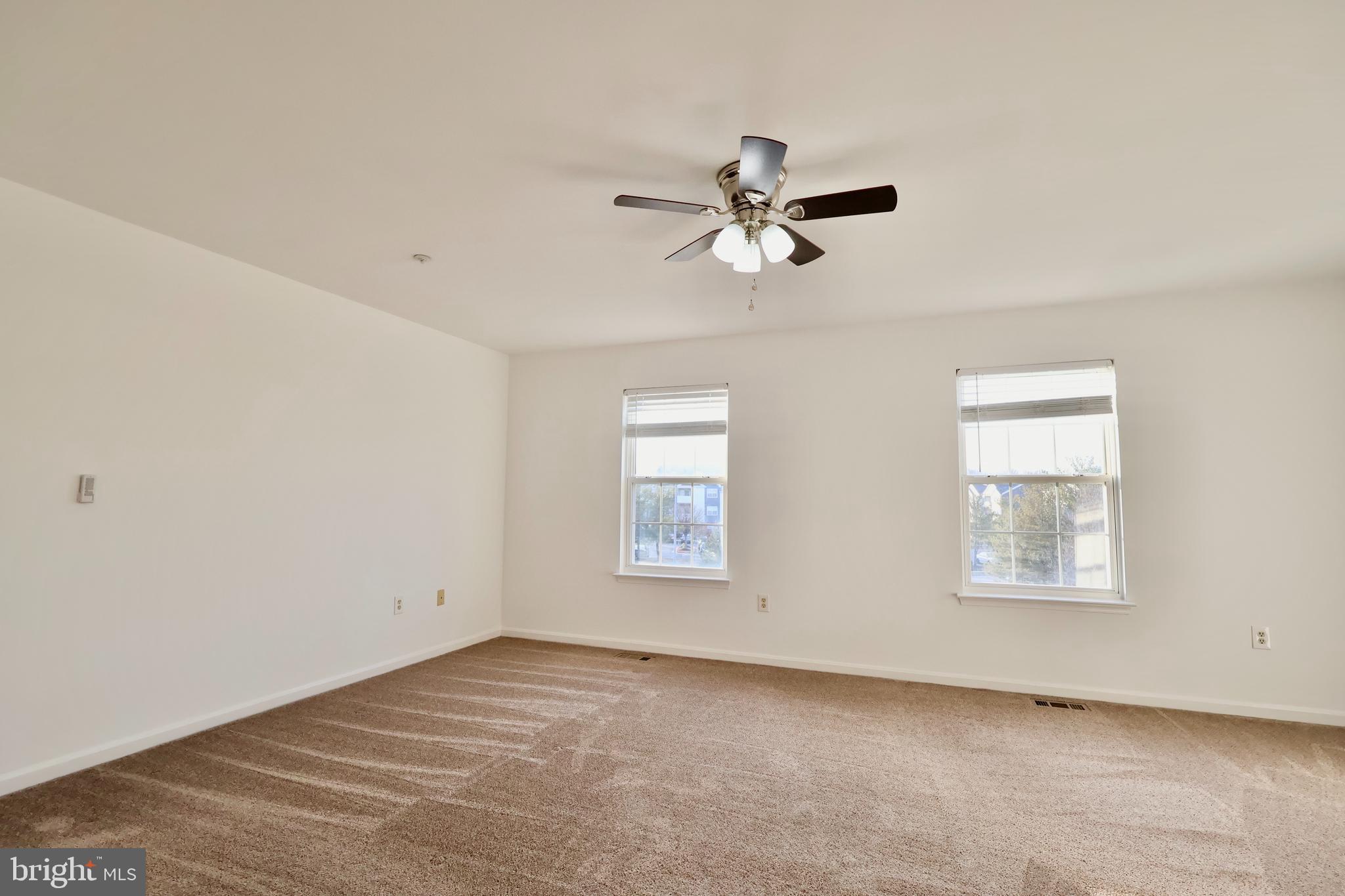 303 Three Sirens Odenton, MD 21113 - Photo 13 of 24 a view of room with window and ceiling fan