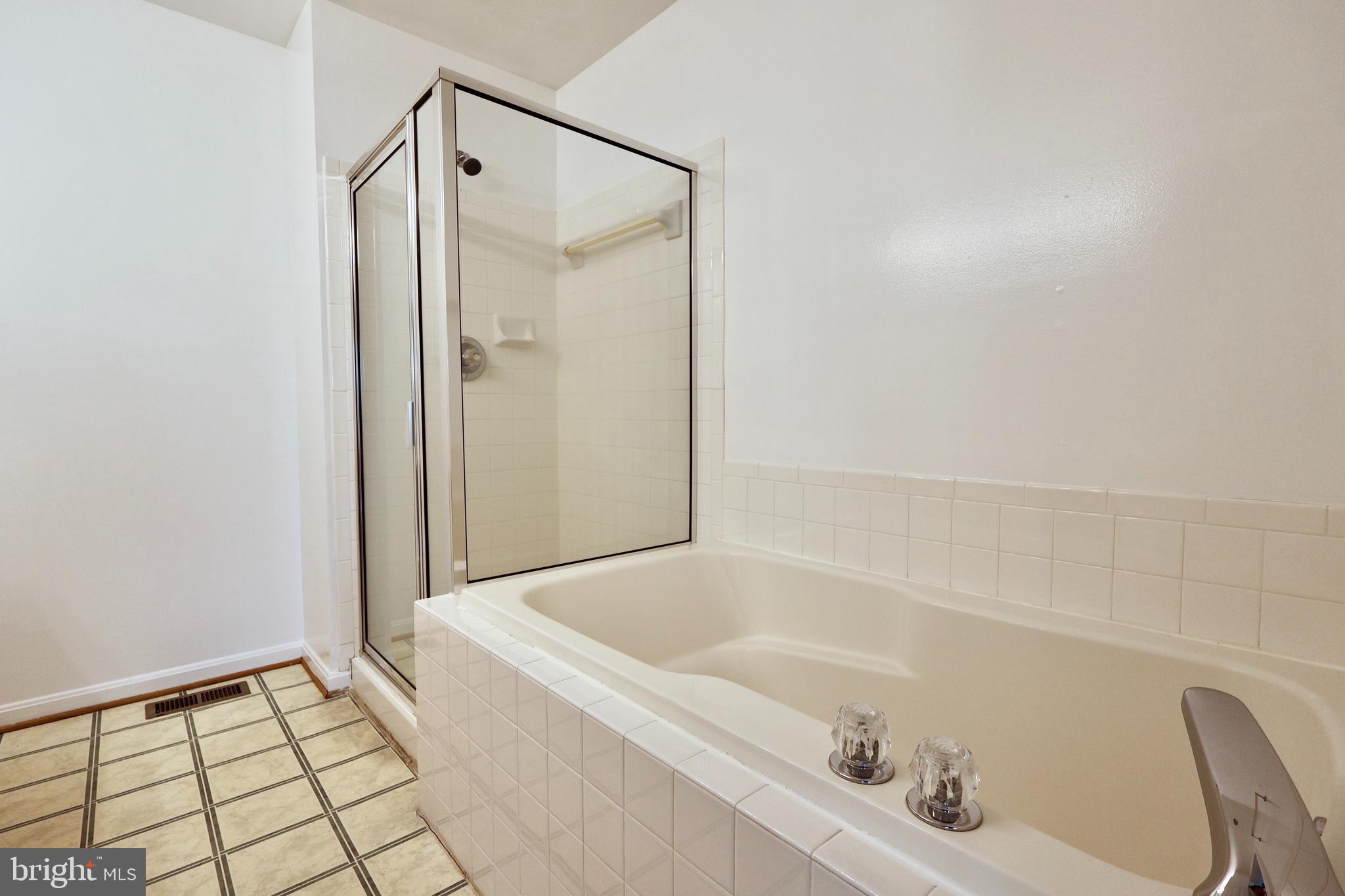 303 Three Sirens Odenton, MD 21113 - Photo 17 of 24 a bathroom with a bathtub and a shower