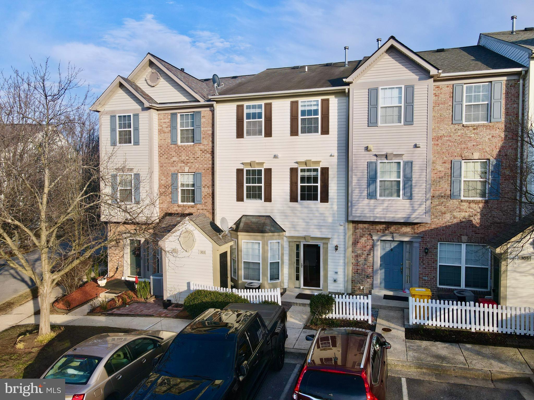 303 Three Sirens Odenton, MD 21113 - Photo 2 of 24 a front view of a residential apartment building with a yard