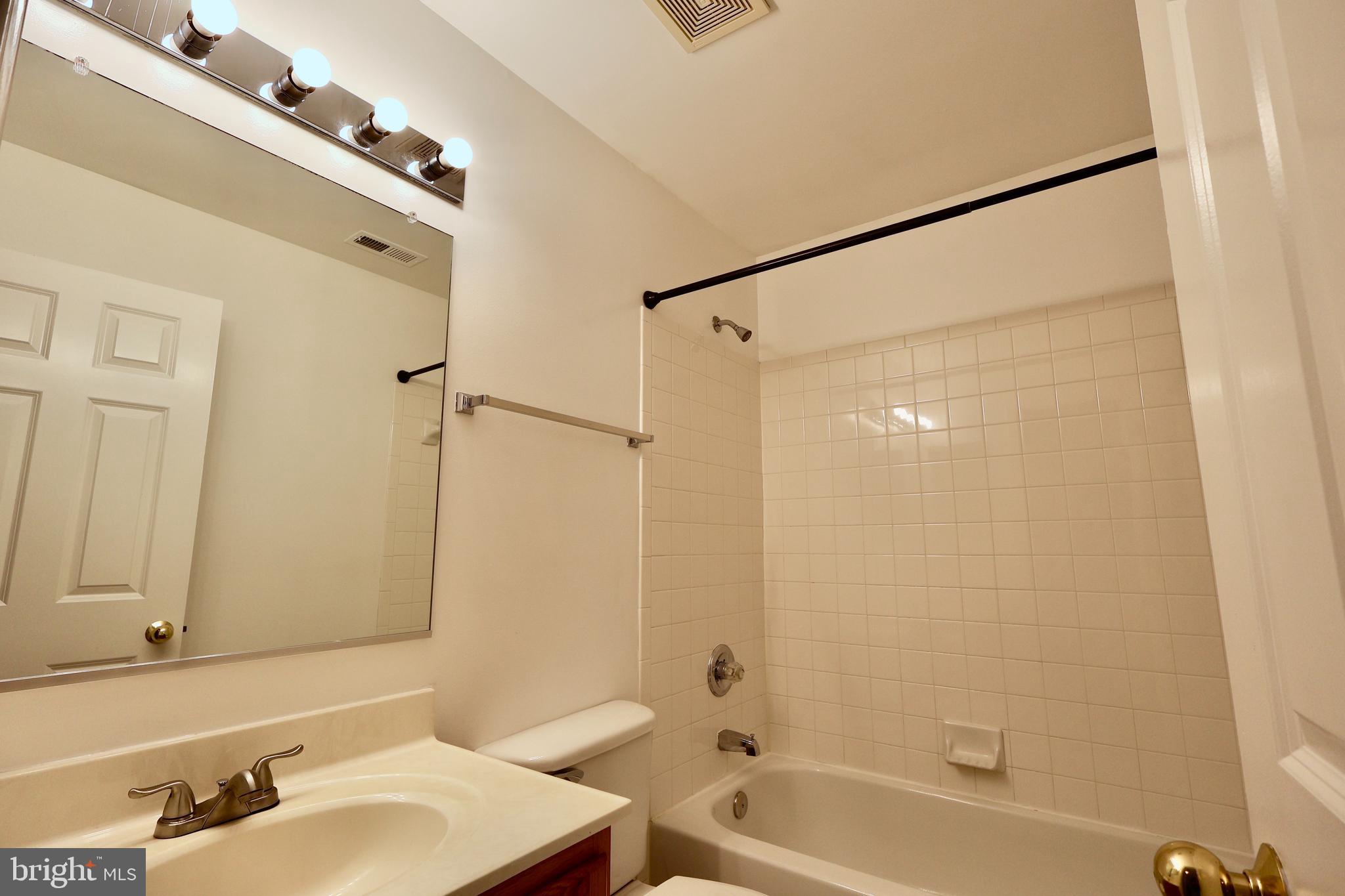 303 Three Sirens Odenton, MD 21113 - Photo 22 of 24 a bathroom with a tub shower sink and vanity