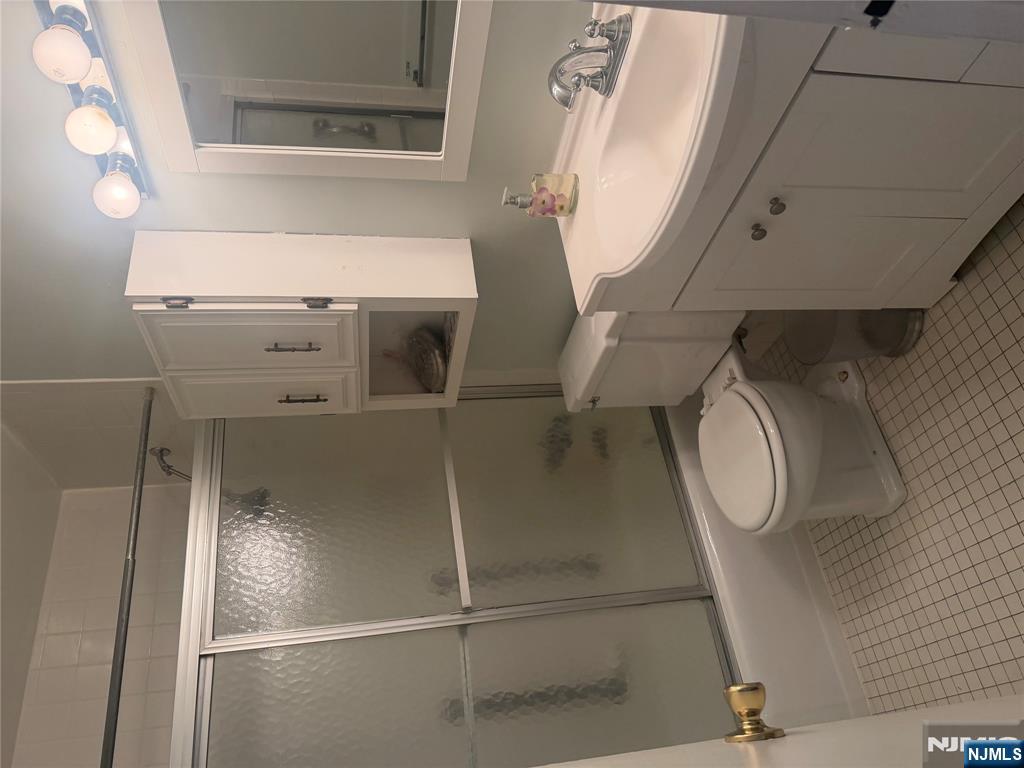 280 Prospect Avenue, Unit 5D Hackensack, NJ 07601 - Photo 14 of 21 a bathroom with a sink toilet and shower