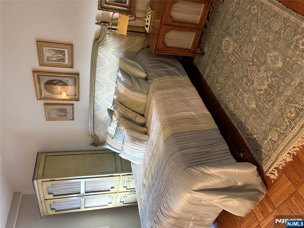 280 Prospect Avenue, Unit 5D Hackensack, NJ 07601 - Photo 15 of 21 a bedroom with a bed and a painting on the wall