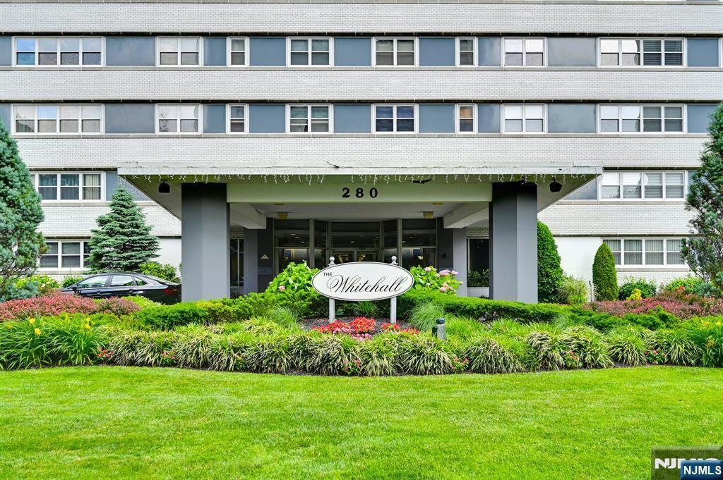 280 Prospect Avenue, Unit 5D Hackensack, NJ 07601 - Photo 2 of 21 a front view of a building with a garden and plants