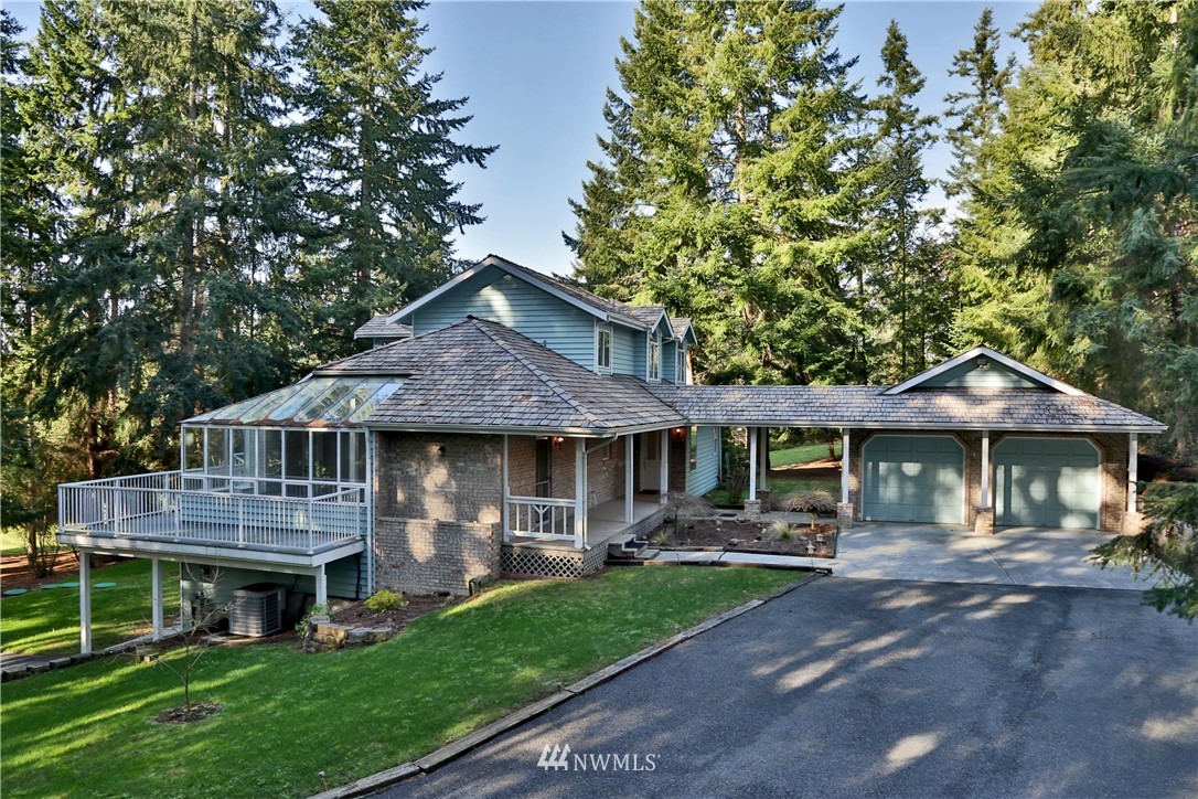 5621 Cameron Road Freeland, WA 98249 - Photo 1 of 25 a front view of a house with a garden