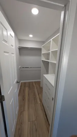 a view of walk in closet with empty racks