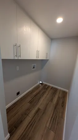 a view of an empty room and wooden floor