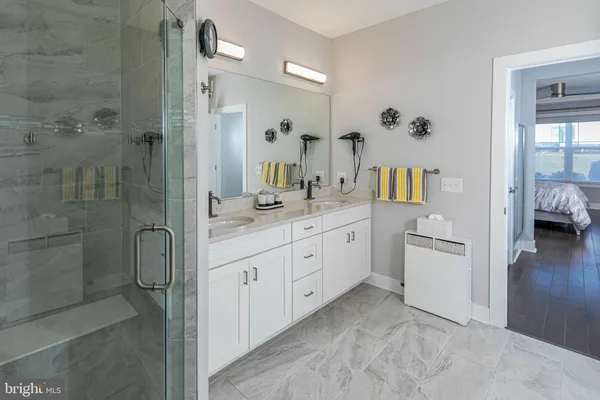 a spacious bathroom with a granite countertop sink mirror and shower
