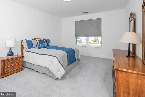 a spacious bedroom with a bed and a window