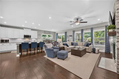a living room with lots of furniture and a large window