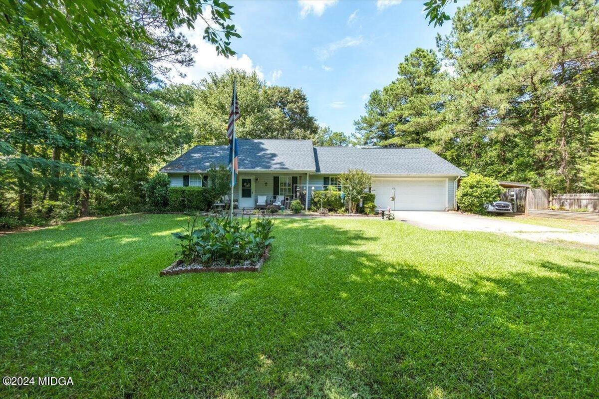 1426 Teagle Road Forsyth, GA 31029 - Photo 1 of 27 a front view of a house with garden