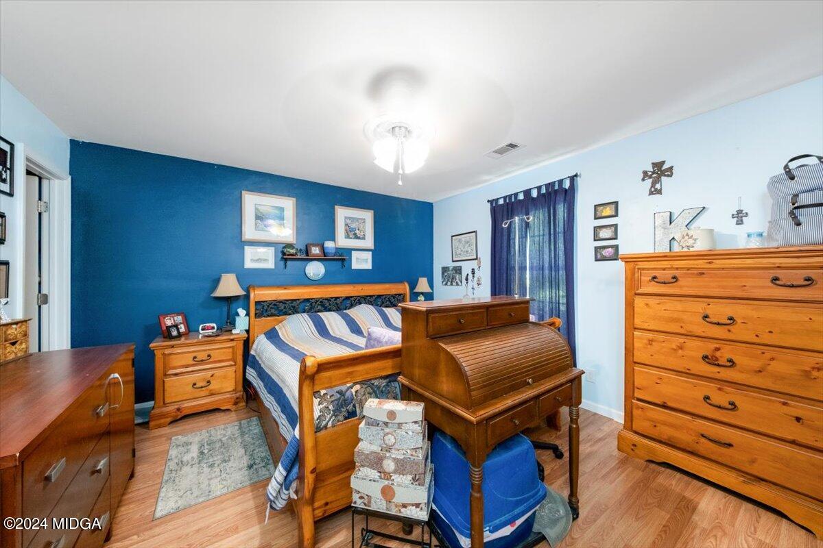 1426 Teagle Road Forsyth, GA 31029 - Photo 12 of 27 a bed room with a bed and a dresser