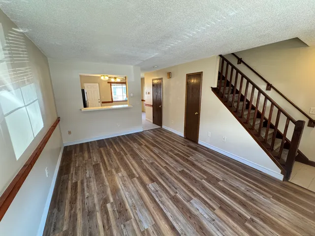 a view of a room with wooden floor and windows